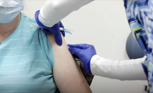 A COVID-19 vaccination being administered.
