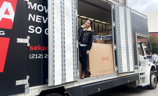 Woman standing in a moving truck. 